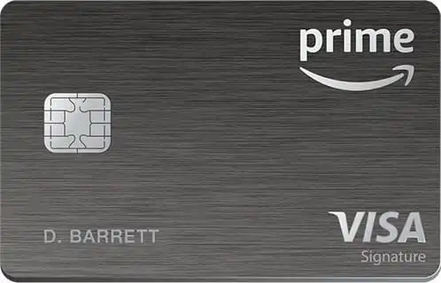 A metallic gray Amazon Prime Visa Signature credit card featuring a chip, prime with Amazon’s smile logo at the top right, and the cardholder name D. Barrett at the bottom left.