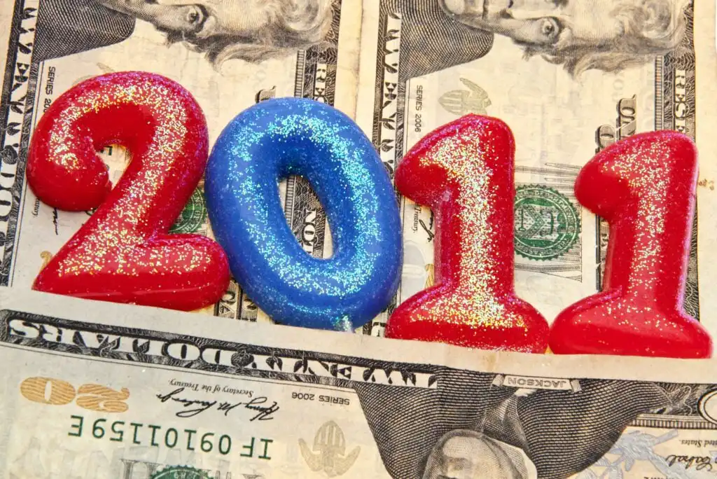 Glittery candles forming the number 2011 are placed on top of U.S. dollar bills.