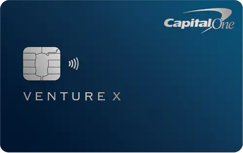 A dark blue Capital One Venture X credit card featuring a chip, contactless payment symbol, and the Capital One logo in the top right corner.