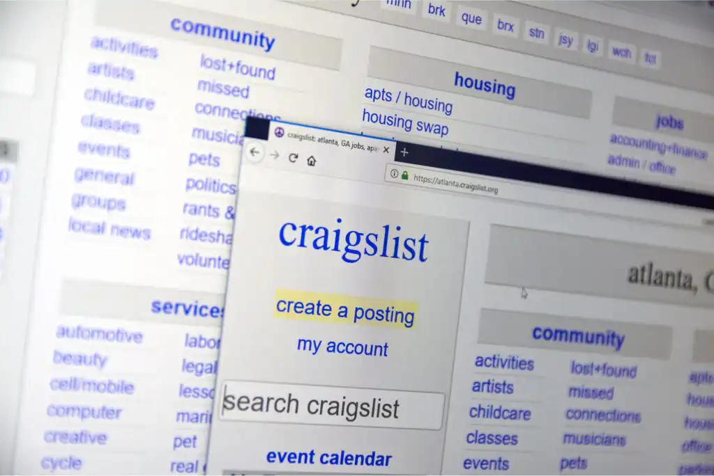 A computer screen displays the Craigslist homepage with sections for community, housing, and services, and a pop-up window showing options to create a posting, access an account, and search Craigslist.