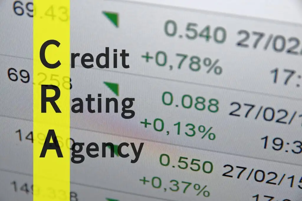 The image shows a financial screen with numbers and green arrows. On the left, a yellow vertical bar displays the letters CRA in black, with the words Credit, Rating, and Agency aligned next to each letter.