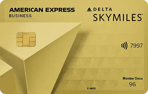 A gold American Express Delta SkyMiles Business credit card, featuring a paper airplane design, EMV chip, contactless symbol, and the numbers 7997. The card displays Member Since 96.