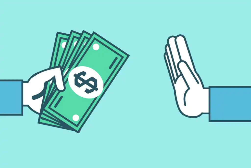 A hand offers several dollar bills while another hand is held up in a gesture signaling refusal or rejection, set against a light blue background.
