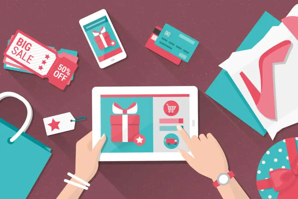 Illustration of hands using a tablet to shop online, with gift icons on the screen. Surrounding are a smartphone, credit cards, sale coupons, shopping bags, a shoe, and a gift box, all on a red surface.