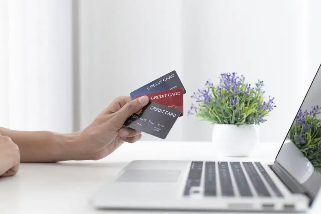 A gray PenFed Pathfinder Rewards Visa Signature credit card with a chip, contactless symbol, and PENFED MEMBER text. The card features subtle diagonal patterns and the Visa Signature logo in the bottom right corner.