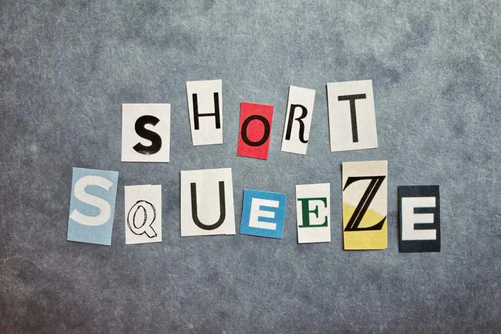 Letters cut from magazines spell out SHORT SQUEEZE on a textured gray background, with each letter in a different font, style, and color.