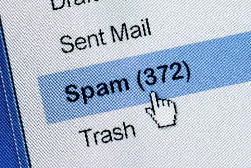 A computer screen shows an email inbox with the cursor pointing at the Spam folder, which has 372 unread messages. Other visible folders include Sent Mail and Trash.