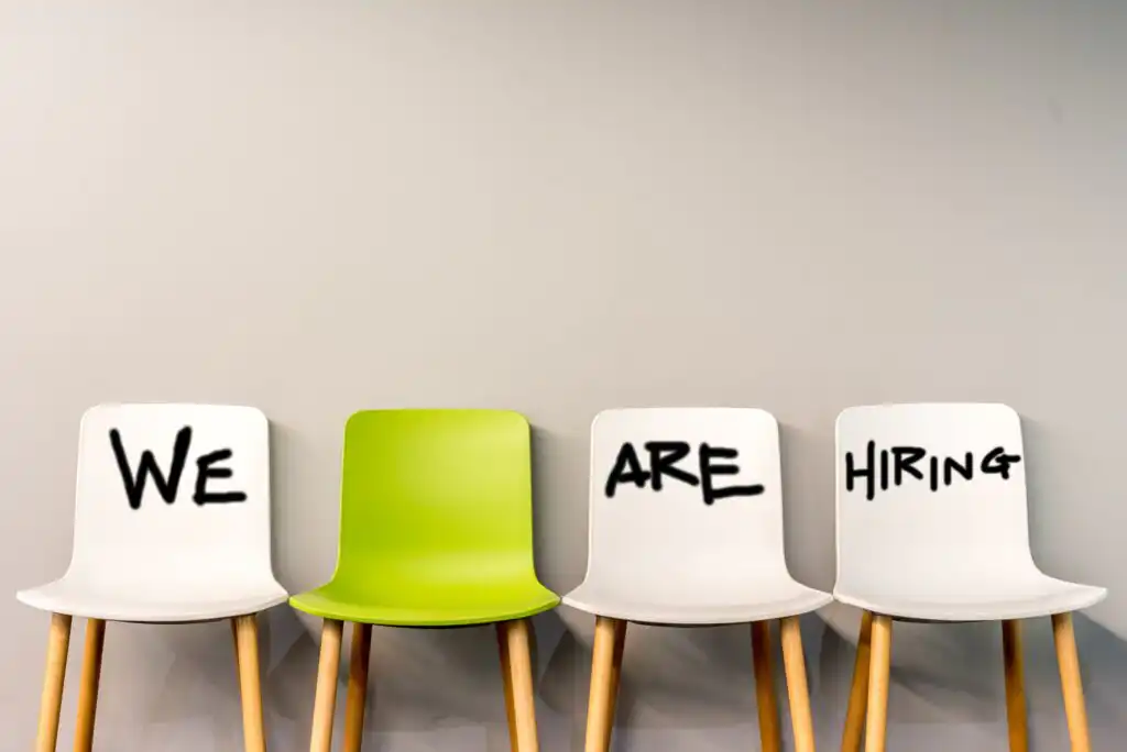 A row of chairs with writing on them.
